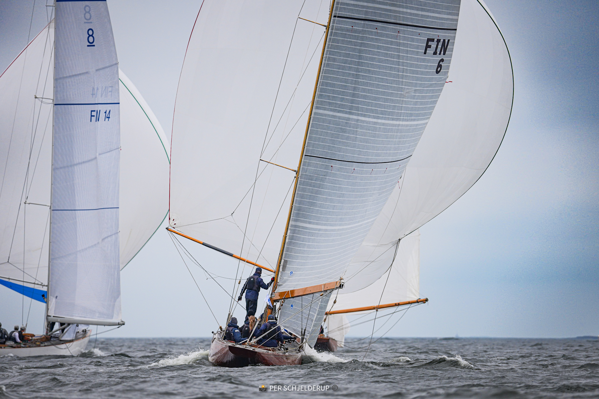 Vågspel (FIN 6) running under spinnaker off Helsinki, FIN 14 astern.