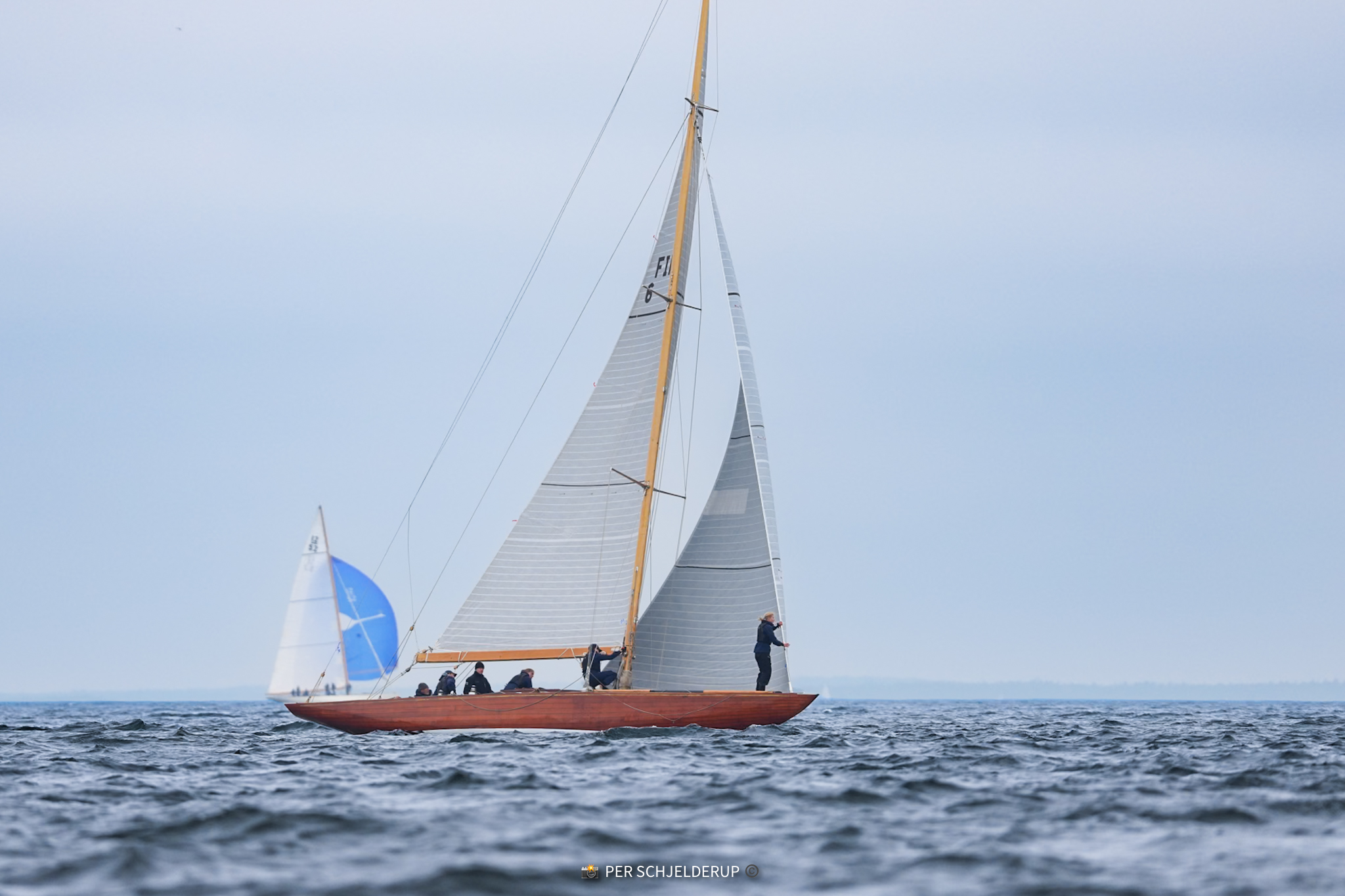 Vågspel on a reach, a spinnaker rising astern.